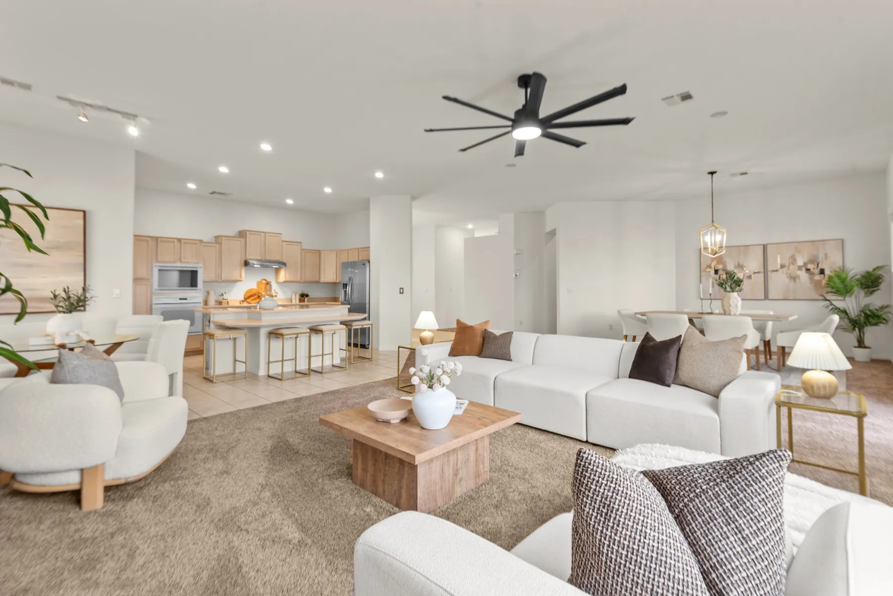A staged great room flowing into the kitchen
