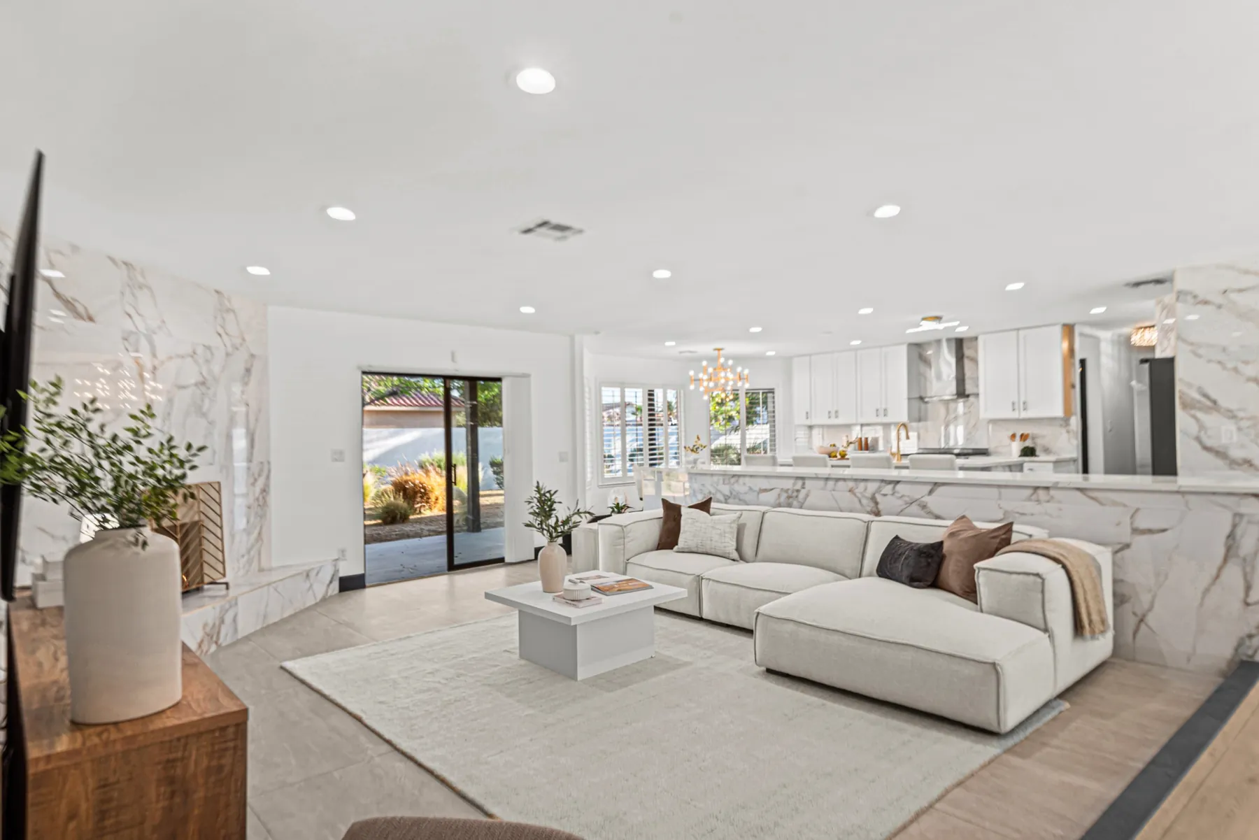A staged living room opening onto the back yard